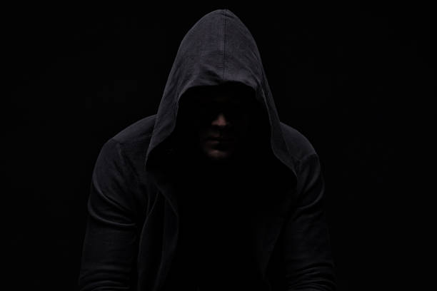 istock Young man in hood and shadow 820106330