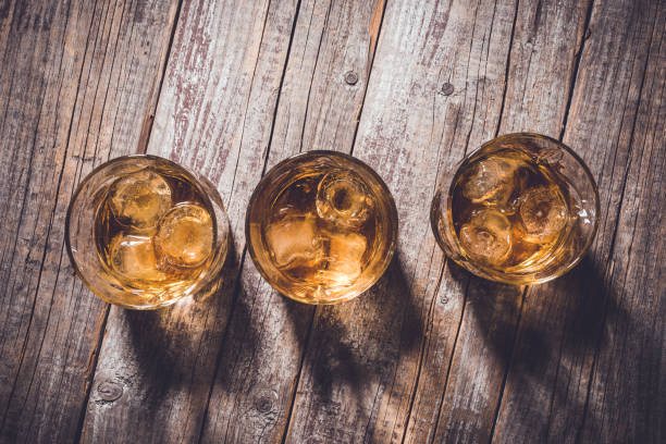 istock Whiskey glasses on an old wooden table. 820111648
