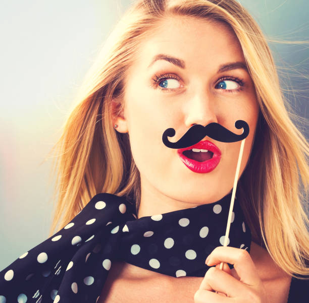 istock Young woman holding paper party sticks 820111652
