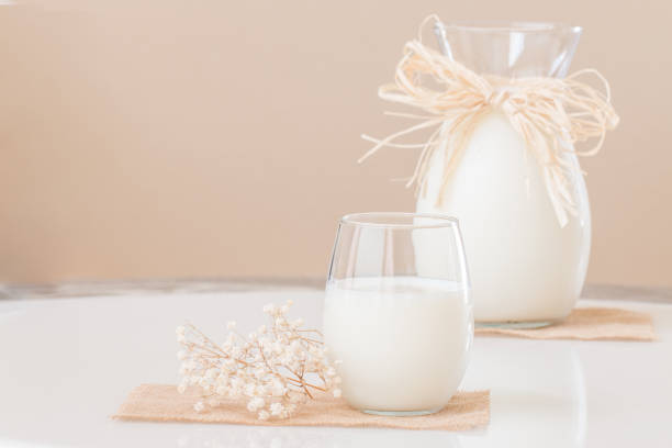 istock Fresh milk in a glass and a pitcher on marble table for breakfast 820111712