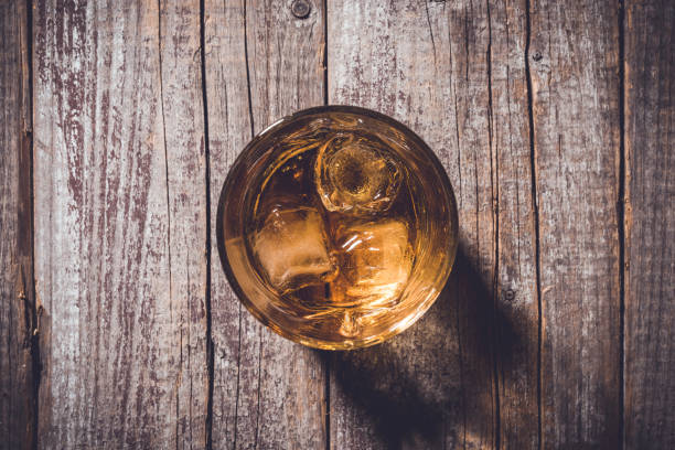 istock Whiskey glass on an old wooden table. 820111850
