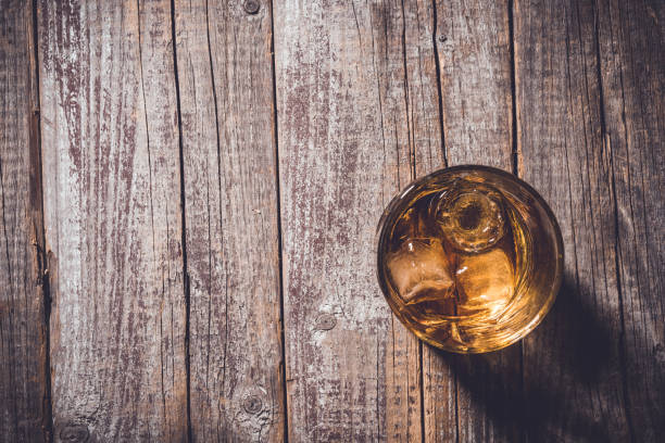 istock Whiskey glass on an old wooden table. 820112028