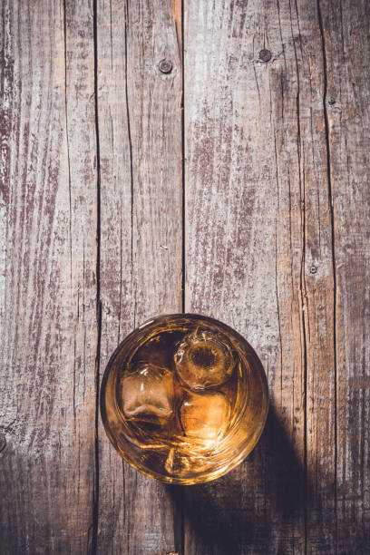 istock Whiskey glass on an old wooden table. 820112150