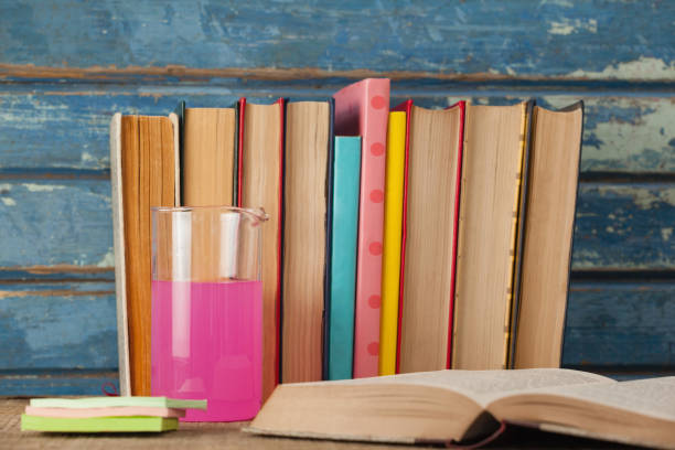 istock Stack of books, chemical beaker and sticky notes 820135402