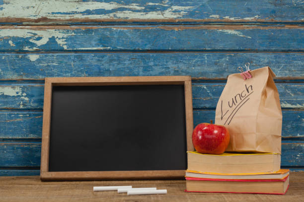 istock Slate, chalk, apple, lunch bag and books 820135540