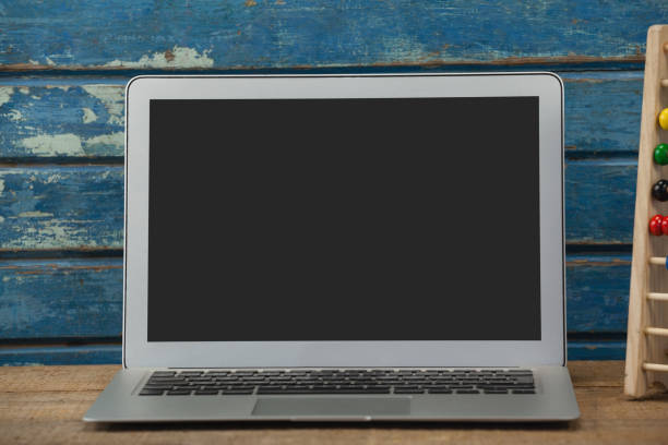 istock Laptop against wooden background 820140692