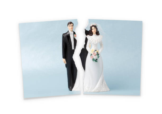 Divorce Divorce.Torn photograf of wedding cake topper relationship difficulties photos stock pictures, royalty-free photos & images