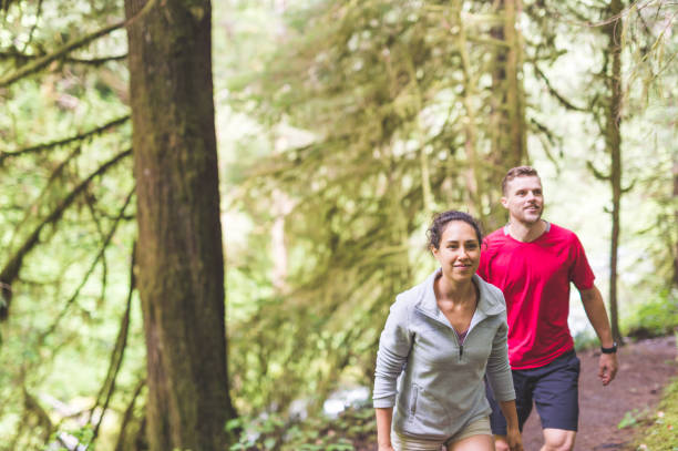 istock Couple running in the forest 820166742