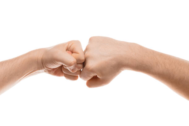 istock Two fists hitting each other hand gesture. Isolated on white 820167236