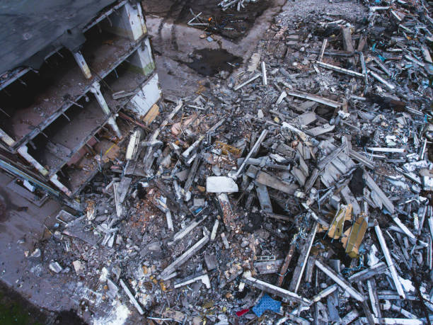 istock A process of buliding demolition, demolition site with heavy bulldozer and excavator with crushing equipment at work, demolished house, shot from air with drone 820173830