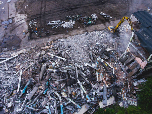istock A process of buliding demolition, demolition site with heavy bulldozer and excavator with crushing equipment at work, demolished house, shot from air with drone 820173906