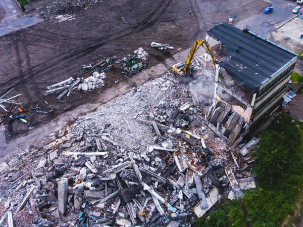 istock A process of buliding demolition, demolition site with heavy bulldozer and excavator with crushing equipment at work, demolished house, shot from air with drone 820173908