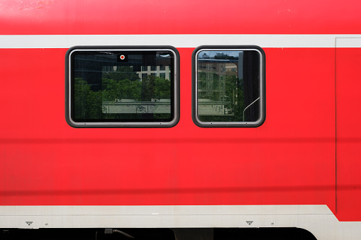 train windows of a red train wagon from outside
