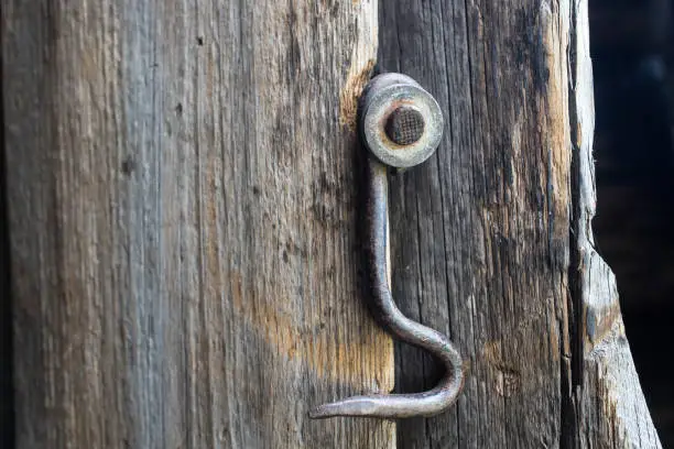 Old lock on the door. True village style.Close-up.Hook.Selective focus.