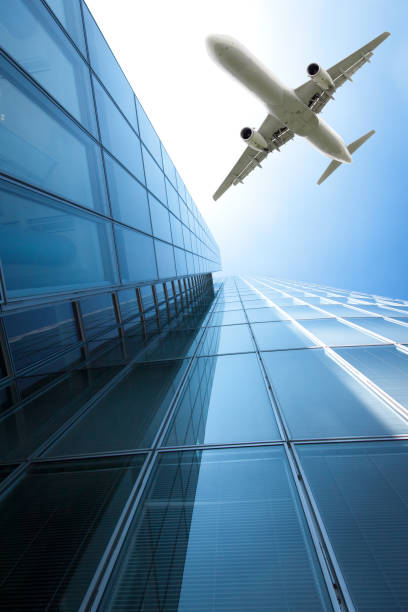 istock aeroplane flying over the skyscrapers. architecture building with flying airplane 820188896