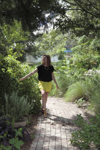 istock Young woman is walking in a park. 820196406