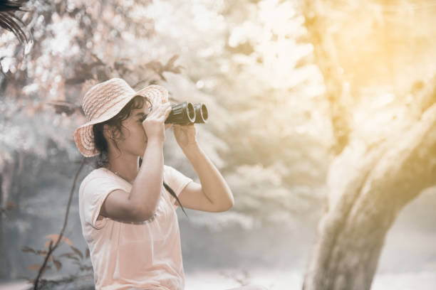 istock Pretty Asian woman looking with  Binoculars. 820196424