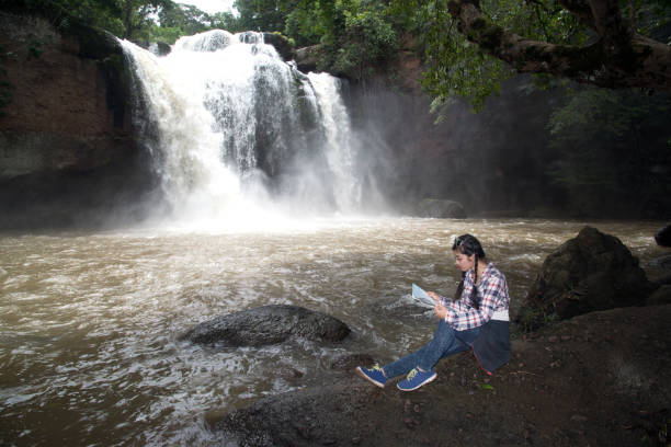 istock Young Asian traveler woman looking a map. 820220104