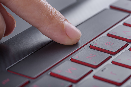 finger pushing space bar button on laptop keyboard