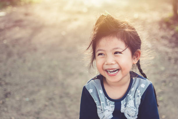 istock Cute Asian baby Smiling in garden copy space. 820243208