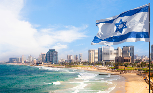 View of Tel Aviv beach in summer time with Israel Flag