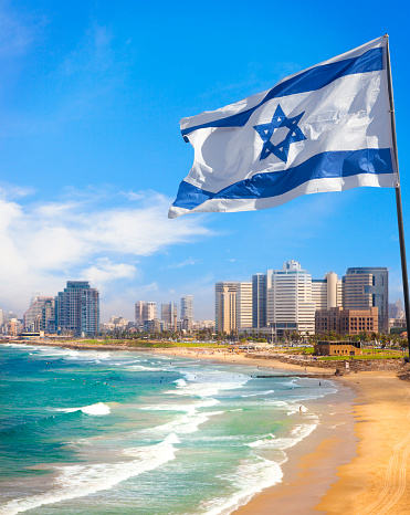 View of Tel Aviv beach in summer time with Israel Flag