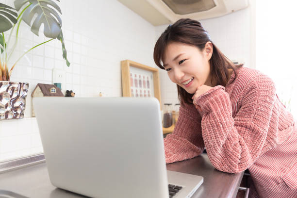istock woman who cooks while watching Laptop 820250542
