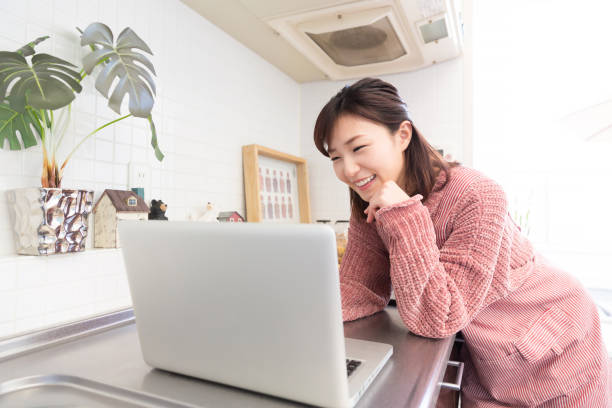 istock woman who cooks while watching Laptop 820250624