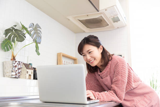 istock woman who cooks while watching Laptop 820250680