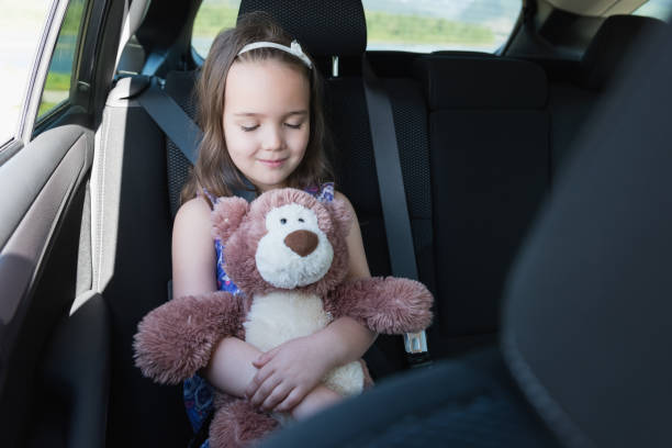 istock Cute girl holding teddy bear while sleeping 820261150