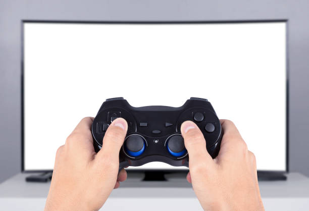 istock hand holding joystick to playing video game on tv (blank screen) 820279880