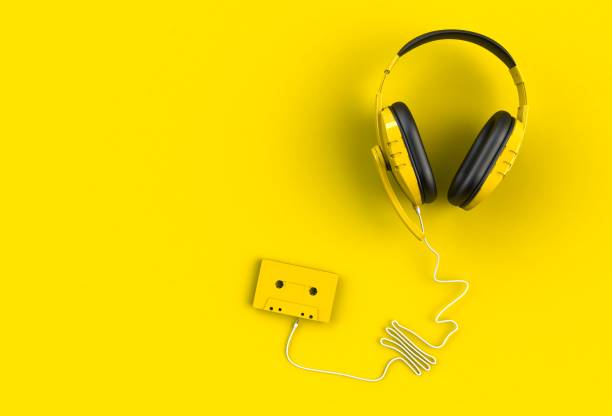 istock Headphones with cassette tape on yellow background, Top view with copyspace for your text, 3D rendering 820299250