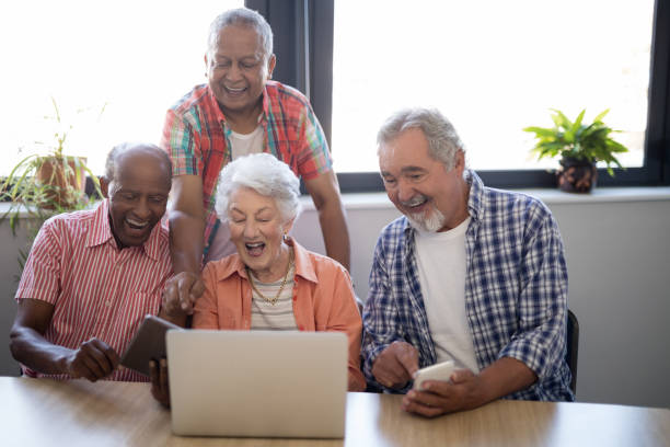 istock Happy senior people using technology at nursing home 820305412
