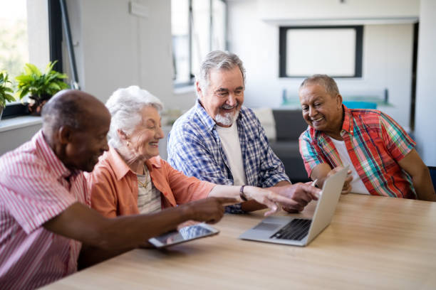 istock Happy senior people pointing at laptop 820305490