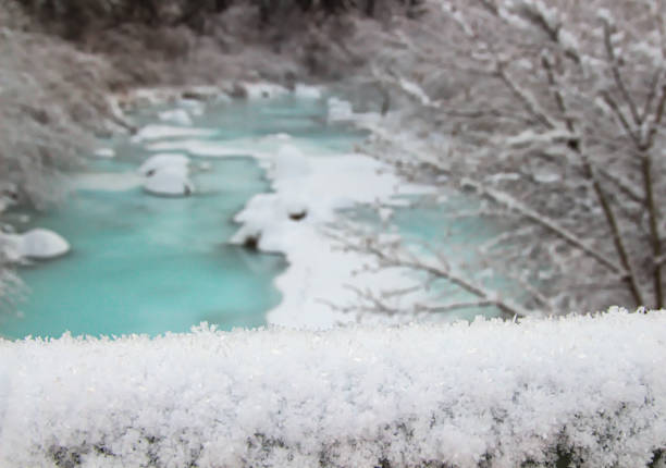 Beautiful winter landscape. Trees and snow on the blue sky background. Frosty day, frozen river. The sun shines brightly