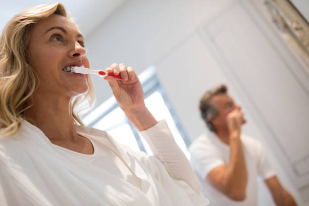 istock Couple brushing teeth in bathroom 820305812