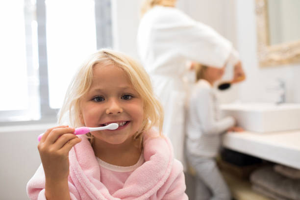 istock Girl brushing teeth in bathroom 820306166