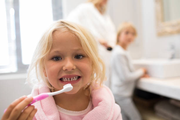 istock Girl brushing teeth in bathroom 820307516