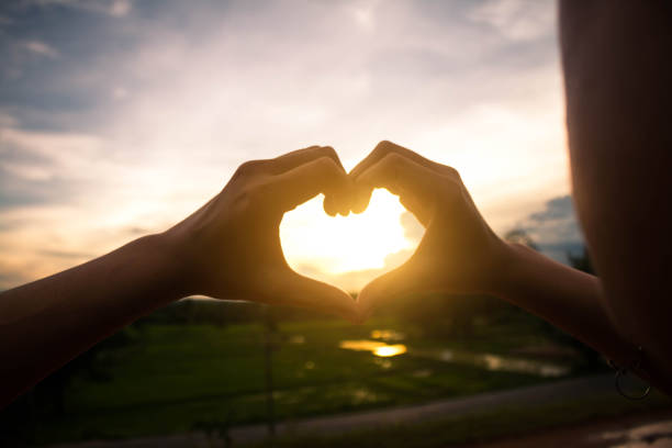 istock Women make hand-shaped heart symbol. 820317950
