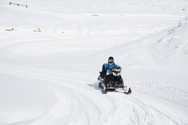 istock Woman driving snowmobile 820320630