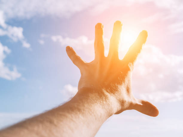 istock Hand of a man reaching to towards sky. 820320796