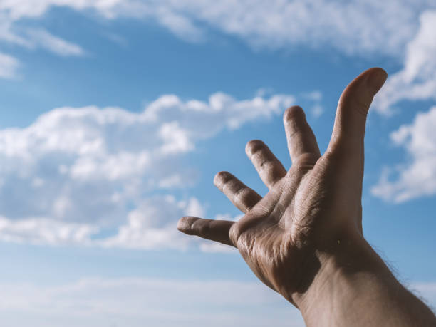 istock Hand of a man reaching to towards sky. 820321102
