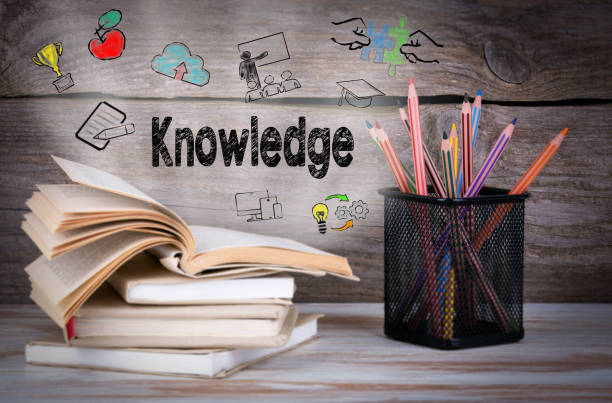 istock Knowledge. Stack of books and pencils on the wooden table. 820324456