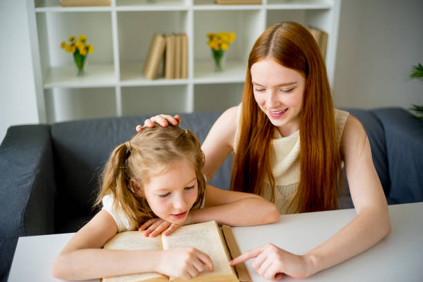 istock Mother reading a book to her daughter 820324466