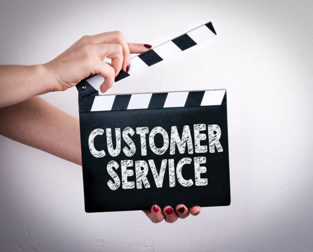 istock Customer Service. Female hands holding movie clapper 820324796