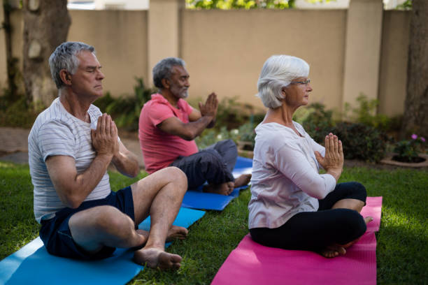 istock Senior people meditating in prayer position 820324918