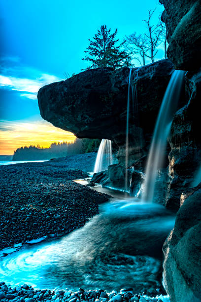 istock Amazing Sandcut beach waterfalls with colorful sky background 820325666