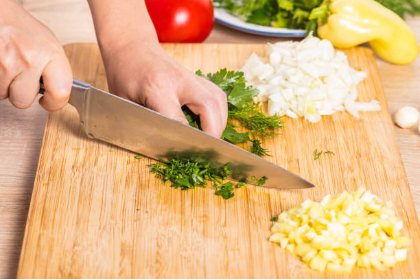 istock Cook cuts greens with a knife 820334726