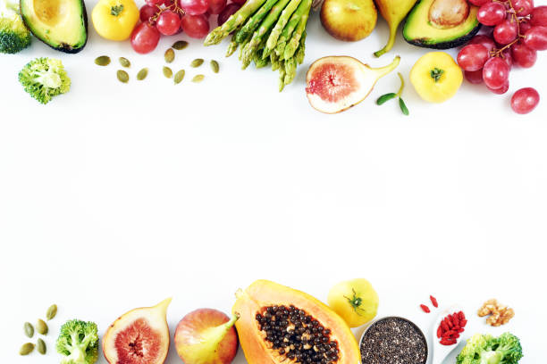 Fresh fruits and vegetables food frame over white background with empty space.