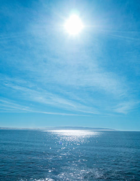 istock bright sun in blue sky with clouds over the sea 820335162